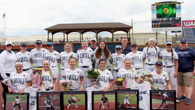 The softball team at 365英国上市杜波依斯分校 gathering for a team photo during senior day festivities at Heindl Field